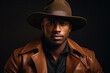 © wolfhound911 - Portrait of a dark-skinned handsome man looking to the side. Dressed in a brown jacket and black hat. Portrait on black background.