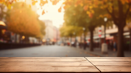 Empty wooden table top with blur background of city street in autumn