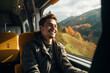 © hutangach - Happy, smiling young man traveling in train.