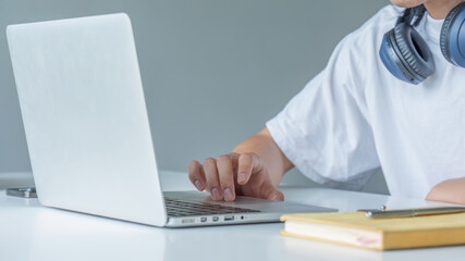 Closeup shot of hands using laptop and typing on keyboard, searching information