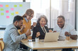 © itchaznong - Diverse businesspeople raise hands celebrate after successful investment strategy at office