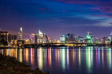 Wall Mural - Ho Chi Minh City skyline and the Saigon River at sunset.  It is a popular tourist destination of Vietnam.