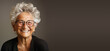 Portrait of a happy old woman with eyeglasses, smiling face, pensioner with white hair, clean studio background