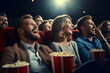 © MNStudio - Group of people watching a movie in cinema. Men and women with excited expressions on their faces.