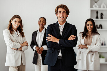 Wall Mural - Successful business team. European businessman standing with folded arms in front of his employees, posing in office