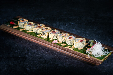 Wall Mural - Tasty sushi rolls served on tray on marble surface