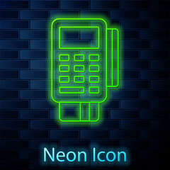 Poster - Glowing neon line POS terminal with inserted credit card and printed reciept icon isolated on brick wall background. NFC payment concept. Vector