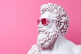 Greek sculpture of the god Zeus wearing rose-colored glasses on a pink background.