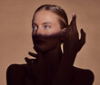 © LuneVA/peopleimages.com - Spotlight, face or woman in shadow with beauty and creative aesthetic in studio background. Light on eyes, person or elegant model with dark side, art or style thinking of skincare, glow or cosmetics