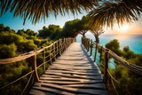 Fototapeta Natura - The wooden bridge overlooking the sea leads to an island with palm trees. It's a rope bridge