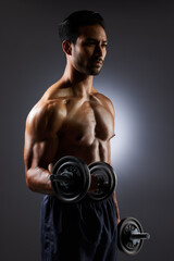 Fitness, dark and a man with weights on a black background for muscle, health and exercise. Sports, idea and an Asian bodybuilder or strong athlete doing weightlifting for training with power