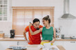© Sevendeman - Asian Wife cooking for husband and he tastes the delicious food with smile.