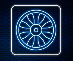 Glowing neon line Alloy wheel for car icon isolated on brick wall background. Vector