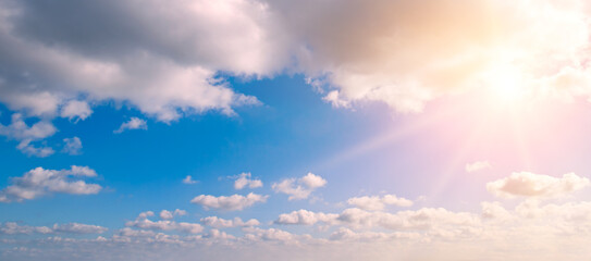 Wall Mural - bright sun, blue sky and light clouds. Wide photo.