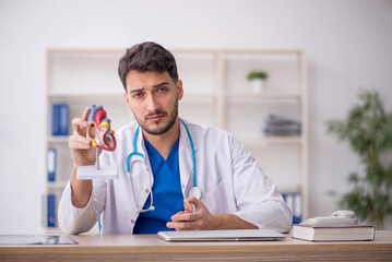 Sticker - Young male doctor cardiologist sitting at the hospital