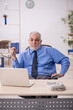 © Elnur - Old male employee working in the office