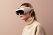 © Romana - a young woman wearing new revolutionary gaming technology - virtual or augmented reality glasses, studio portrait on beige colored background, copy space for text