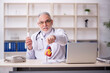 © Elnur - Old male doctor cardiologist working in the clinic