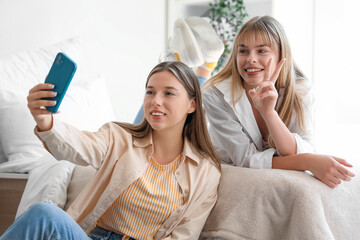 Poster - Female students taking selfie in dorm room