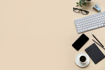 Keyboard, cup of coffee and stationery on beige background