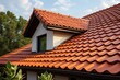 Sloped red clay tile roof with round beaver tail edge