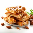 Pieces of delicious peanut brittle with a white background. Generative AI. 
