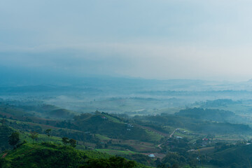 Wall Mural - Beautiful landscape of mountain with view into misty valley in morning time. fog in a mountains valley.