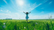 A woman jumps across the meadow with her arms outstretched in joy.