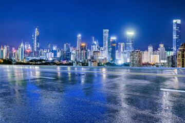 Wall Mural - Asphalt highway and urban skyline with modern buildings at night in Shenzhen, Guangdong Province, China. Road and city buildings after the rain.