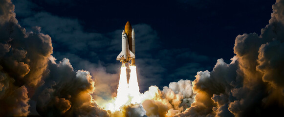 launch of space shuttle atlantis, spaceship takes off into the night sky on a mission. rocket starts