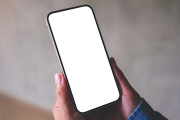 Mockup image of a woman holding mobile phone with blank desktop screen