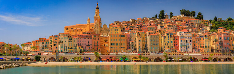 Wall Mural - Colorful house facades above the Mediterranean Sea and beach in Old Town Vieille Ville of Menton on the French Riviera, South of France on a sunny day