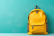 © jchizhe - Yellow school backpack on pastel green background. Copy space. Back to school concept. Backpack with school supplies