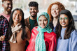 Group of young multiracial friends smiling on camera outdoor - Inclusion, diversity and friendship concept - Main focus on muslim girl face