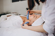 © Roman - Woman getting microcurrent procedure facelift. Beautician doing anti-aging, to perform facial tightening and toning.