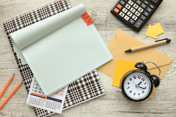 Wall Mural - Notepad and desk clock mockup on wooden table, with copy space for text. Flat lay, photo mockup from above.