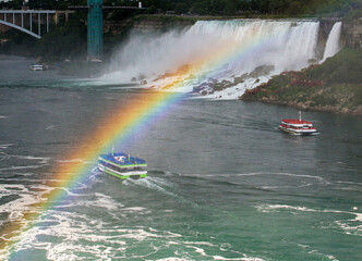 rainbow over tour boats and the american falls of niagara falls