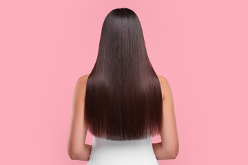 Wall Mural - Woman with healthy hair after treatment on pink background, back view