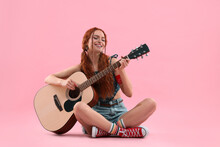 Stylish Young Hippie Woman Playing Guitar On Pink Background