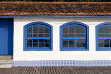 House With Arched Windows, In Blue Wood, White Wall With Portuguese Tiles. Details Of Brazilian Colonial Architecture.