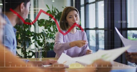 Wall Mural - Animation of red graphs moving over asian woman giving doucuments to colleagues at office