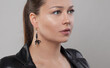 © millaf (Nemchinova) - Gold and black earring on ear of glamorous woman