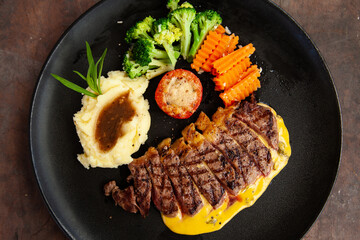 Wall Mural - Striploin angus steak with mashed potato and grilled vegetable