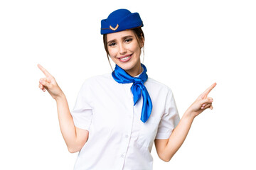 Poster - Airplane stewardess over isolated chroma key background pointing finger to the laterals and happy