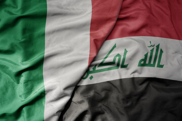 Wall Mural - big waving national colorful flag of italy and national flag of iraq .