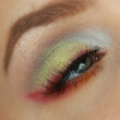 Chinese New Year makeup with golden shimmer and red eye liner. Colorful festival eye makeup look.