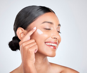 smile, cream and woman with beauty, cosmetics or apply lotion on a white studio background. person, 