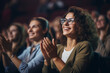 © Keitma - Woman in a audience in a theater applauding clapping hands. cheering and sitting together and having fun