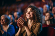 © Keitma - Woman in a audience in a theater applauding clapping hands. cheering and sitting together and having fun