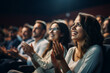 © Keitma - Woman in a audience in a theater applauding clapping hands. cheering and sitting together and having fun